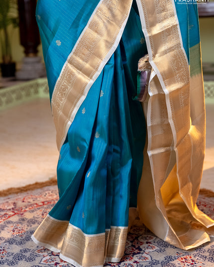 Kanchipuram silk saree dual shade of teal bluish green and cream with allover zari weaves and zari woven korvai border