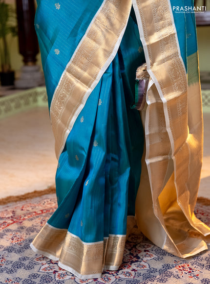 Kanchipuram silk saree dual shade of teal bluish green and cream with allover zari weaves and zari woven korvai border
