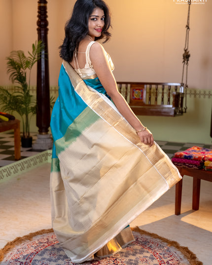 Kanchipuram silk saree dual shade of teal bluish green and cream with allover zari weaves and zari woven korvai border