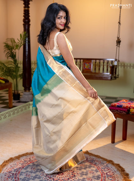 Kanchipuram silk saree dual shade of teal bluish green and cream with allover zari weaves and zari woven korvai border