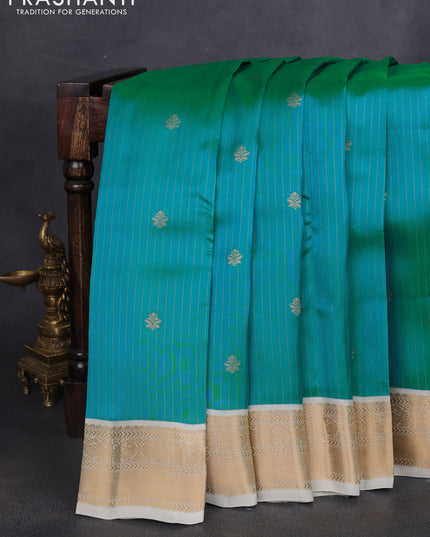 Kanchipuram silk saree dual shade of teal bluish green and cream with allover zari weaves and zari woven korvai border