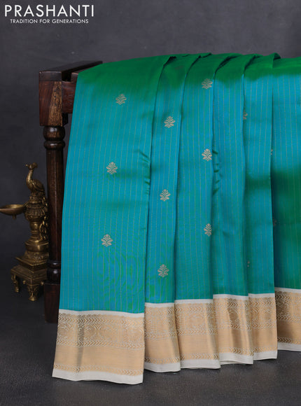 Kanchipuram silk saree dual shade of teal bluish green and cream with allover zari weaves and zari woven korvai border
