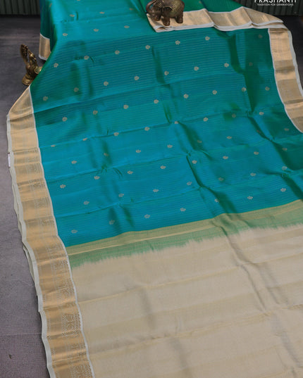 Kanchipuram silk saree dual shade of teal bluish green and cream with allover zari weaves and zari woven korvai border