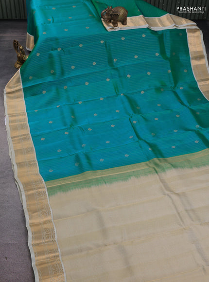 Kanchipuram silk saree dual shade of teal bluish green and cream with allover zari weaves and zari woven korvai border