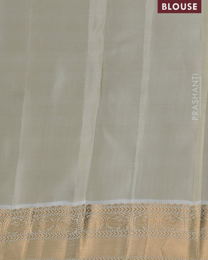 Kanchipuram silk saree dual shade of teal bluish green and cream with allover zari weaves and zari woven korvai border