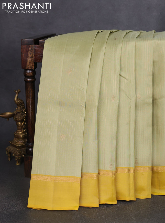 Kanchipuram silk saree pista green and mustard yellow with allover zari weaves and zari woven simple border