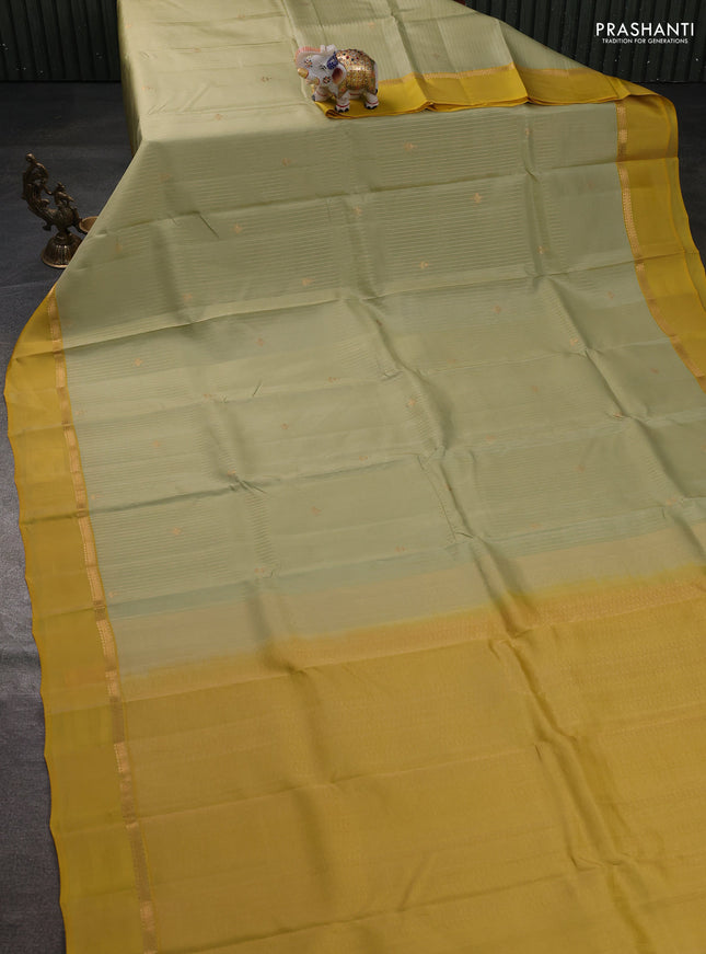 Kanchipuram silk saree pista green and mustard yellow with allover zari weaves and zari woven simple border