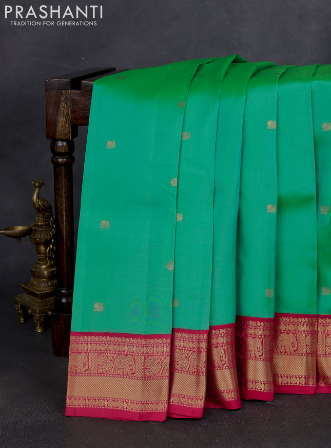 Kanchipuram silk saree teal green shade and pink with zari woven buttas and zari woven korvai border
