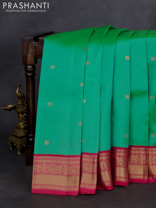 Kanchipuram silk saree teal green shade and pink with zari woven buttas and zari woven korvai border