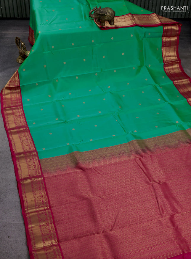 Kanchipuram silk saree teal green shade and pink with zari woven buttas and zari woven korvai border