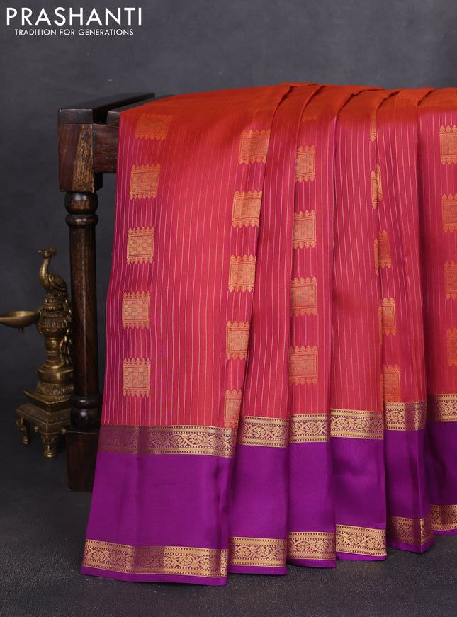 Kanchipuram silk saree dual shade of pinkish orange and purple with allover zari weaves & buttas and rettapet zari woven border