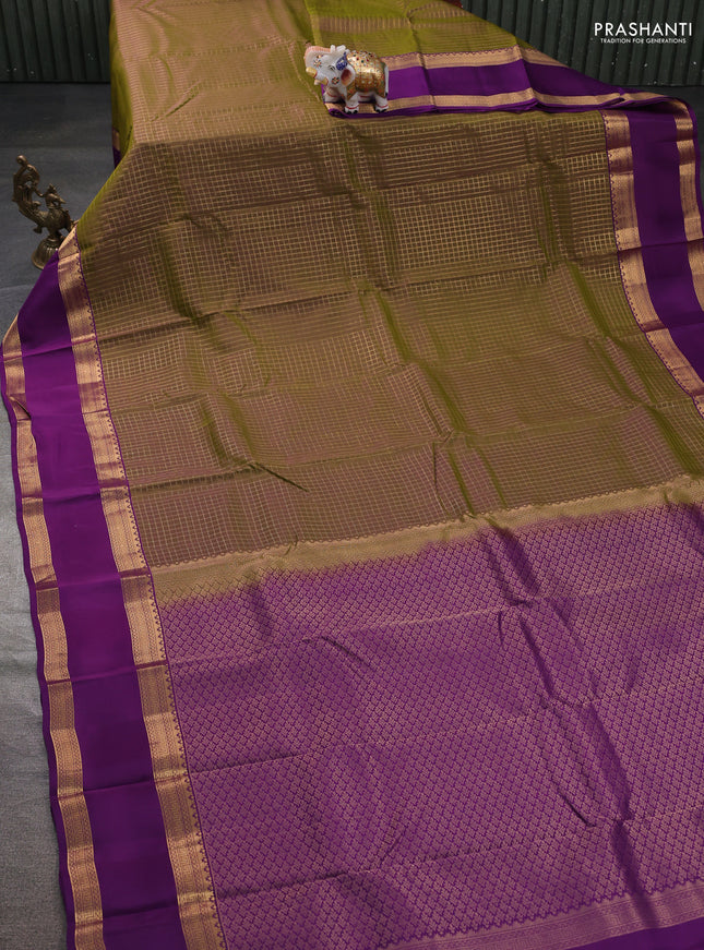 Kanchipuram silk saree dual shade of mehendi green and purple witb allover zari woven checked pattern and rettapet zari woven border