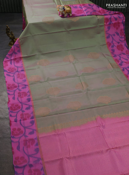 Kanchipuram silk saree dual shade of pastel green and light pink with copper zari woven buttas and zari woven ikat style border
