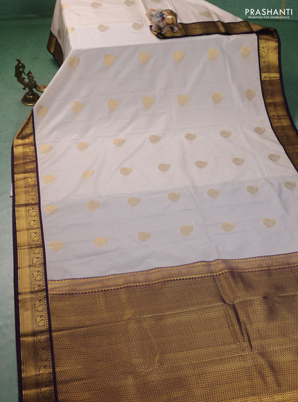 Semi kanchipuram silk saree cream and deep purple with zari woven paisley buttas and zari woven korvai border