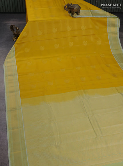 Semi kanchipuram silk saree yellow and pista green with allover zari weaves & buttas and zari woven korvai border