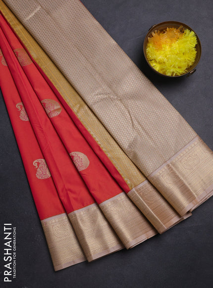 Semi kanchipuram silk saree dual shade of pinkish orange and sandal with paisley zari woven buttas and zari woven korvai border