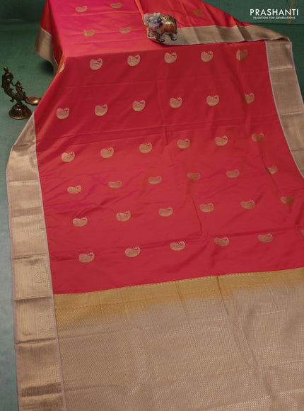 Semi kanchipuram silk saree dual shade of pinkish orange and sandal with paisley zari woven buttas and zari woven korvai border