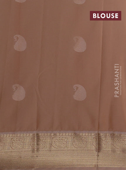 Semi kanchipuram silk saree dual shade of pinkish orange and sandal with paisley zari woven buttas and zari woven korvai border