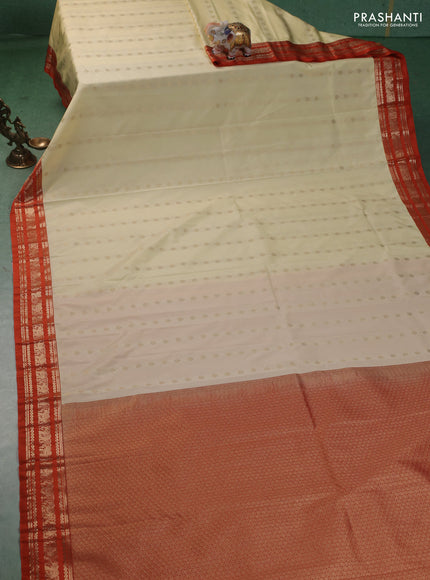 Semi kanchipuram silk saree cream and orange with allover zari woevn buttas and zari woven korvai border