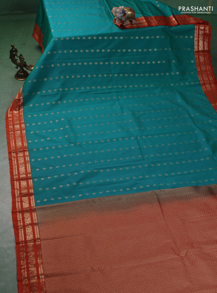 Semi kanchipuram silk saree teal blue and orange with allover zari woevn buttas and zari woven korvai border