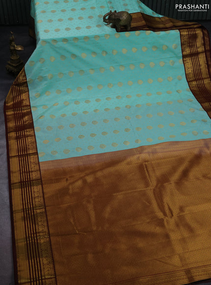 Semi kanchipuram silk saree teal green shade and deep maroon with allover zari woven buttas and zari woven korvai border