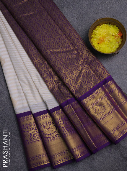 Semi kanchipuram silk saree off white and violet with allover zari weaves & buttas and zari woven korvai border