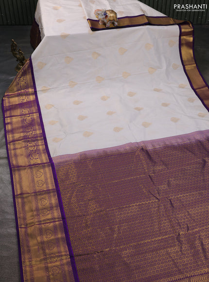 Semi kanchipuram silk saree off white and violet with allover zari weaves & buttas and zari woven korvai border