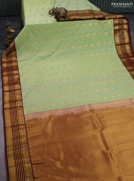 Semi kanchipuram silk saree pista green and maroon with allover zari woven buttas and zari woven korvai border