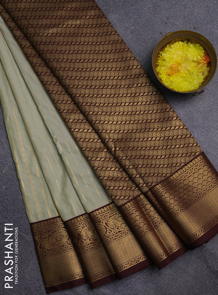 Semi kanchipuram silk saree mild pista green and coffee brown with allover zari weaves and zari woven korvai border