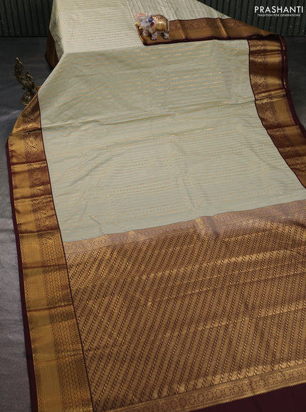 Semi kanchipuram silk saree mild pista green and coffee brown with allover zari weaves and zari woven korvai border