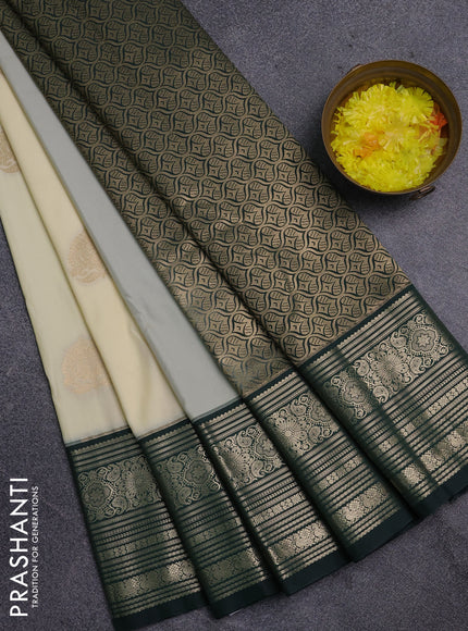 Semi kanchipuram silk saree cream and bottle green with zari woven buttas and long zari woven border