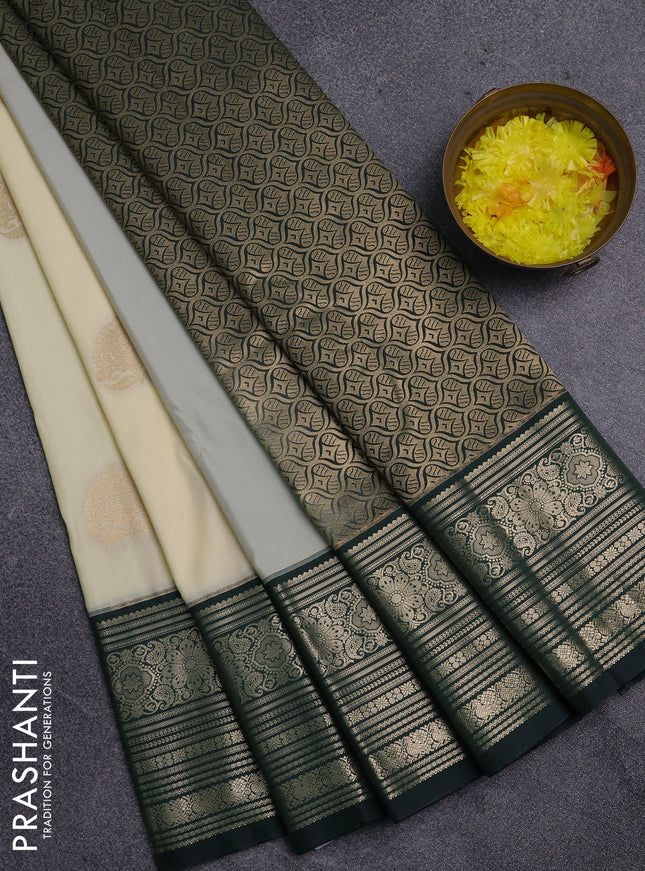 Semi kanchipuram silk saree cream and bottle green with zari woven buttas and long zari woven border