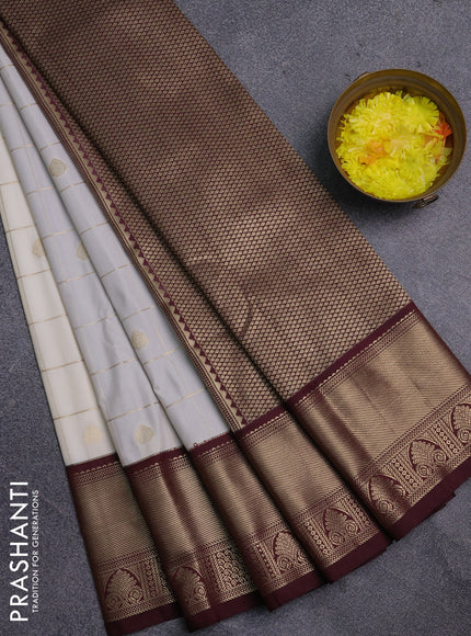 Semi kanchipuram silk saree off white and deep maroon with allover zari checks & buttas and zari woven korvai border