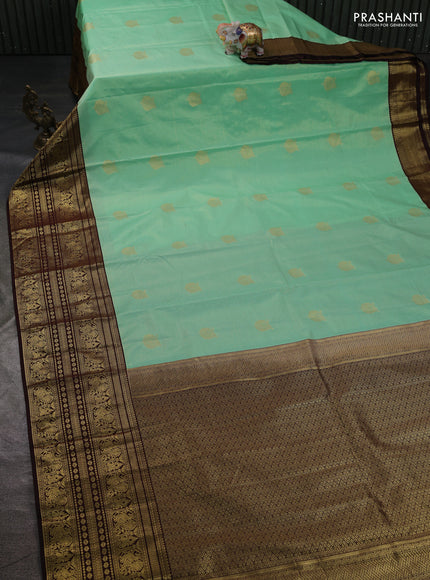 Semi kanchipuram silk saree teal green shade and coffee brown with allover zari weaves & buttas and long zari woven korvai border
