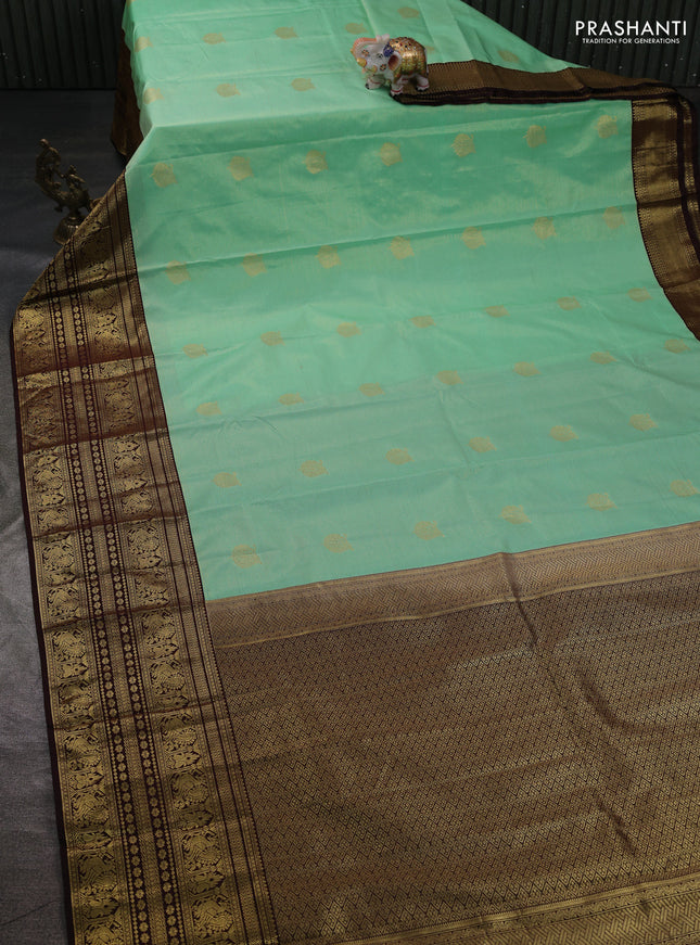 Semi kanchipuram silk saree teal green shade and coffee brown with allover zari weaves & buttas and long zari woven korvai border