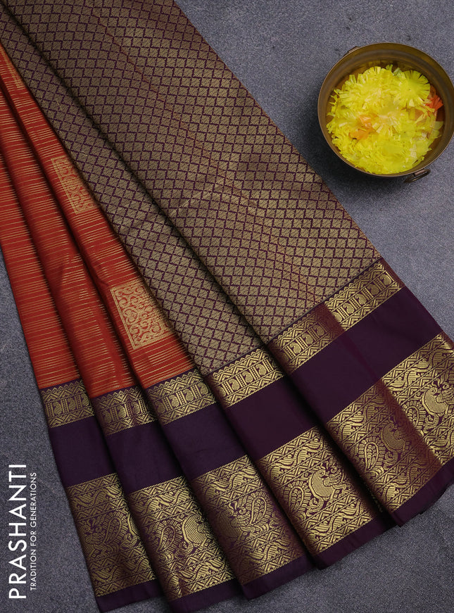 Semi kanchipuram silk saree rust shade and pueple with allover zari weaves & buttas and long rettapet zari woven korvai border