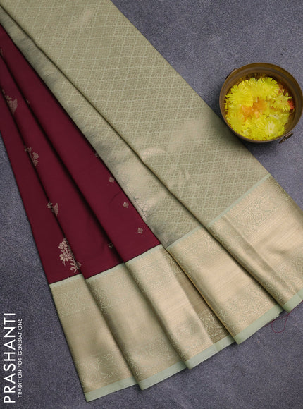 Semi kanchipuram silk saree wine shade and mild pista green with zari woven buttas and long zari woven korvai border