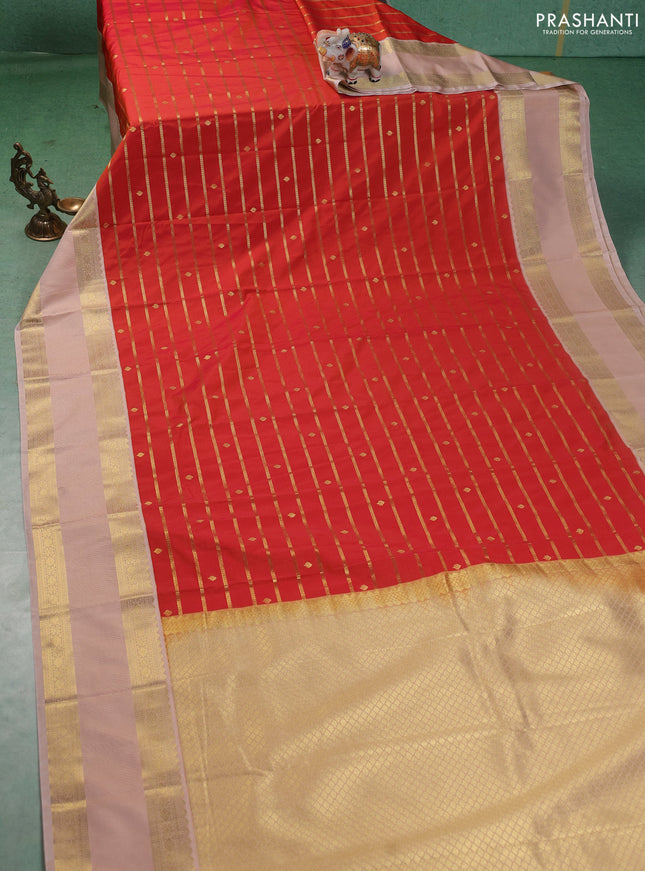 Semi kanchipuram silk saree dual shade of sunset orange and beige with allover zari stripe weaves & buttas and rettapet zari woven korvai border