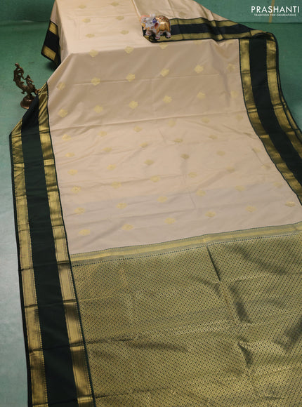 Semi kanchipuram silk saree beige and bottle green with zari woven buttas and rettapet zari woven korvai border