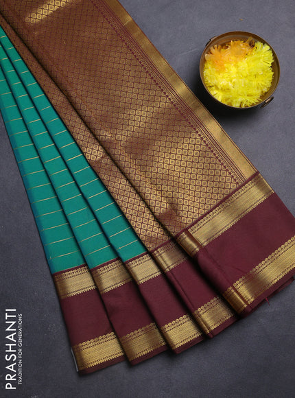 Semi kanchipuram silk saree dual shade of teal bluish green and coffee brown with allover zari stripe weaves and rettapet zari woven korvai border