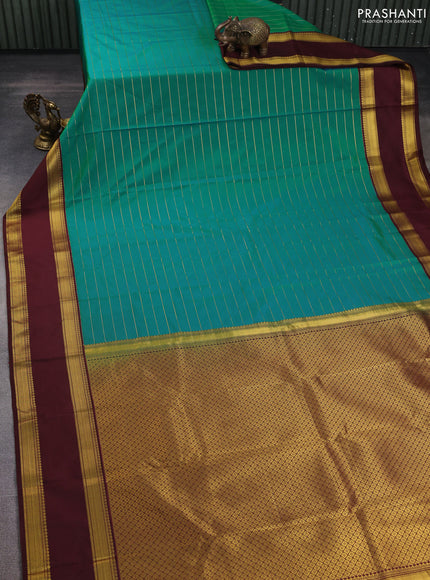 Semi kanchipuram silk saree dual shade of teal bluish green and coffee brown with allover zari stripe weaves and rettapet zari woven korvai border