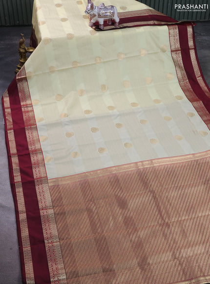 Semi kanchipuram silk saree cream and wine shade with allover zari weaves & buttas and rettapet zari woven korvai border
