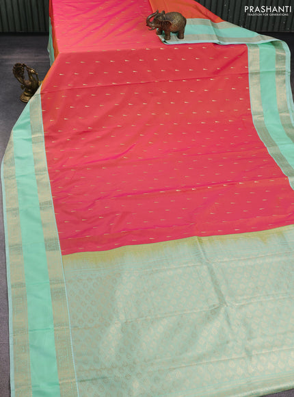 Semi kanchipuram silk saree dual shade of pinkish orange and teal green shade with zari woven buttas and rettapet zari woven korvai border