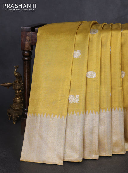 Tissue Kanchipuram silk saree gold with rudhraksha & annam silver zari woven buttas and long silver zari woven border