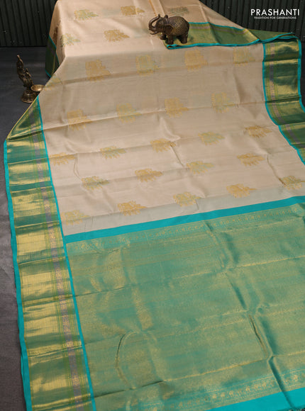 Kora kanchipuram silk saree cream and teal blue with zari woven buttas and rich zari woven border
