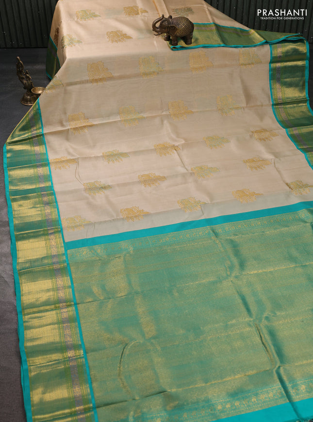 Kora kanchipuram silk saree cream and teal blue with zari woven buttas and rich zari woven border