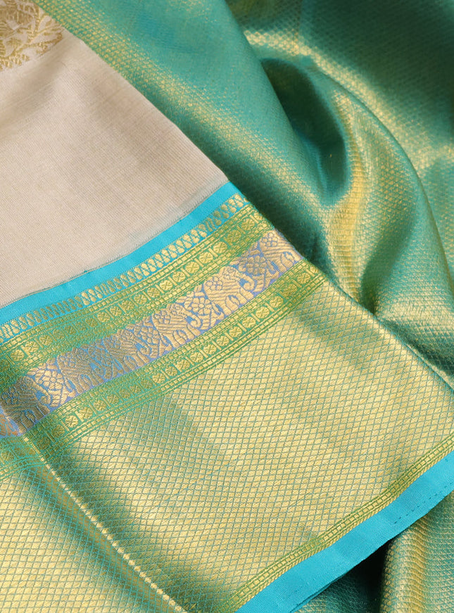 Kora kanchipuram silk saree cream and teal blue with zari woven buttas and rich zari woven border