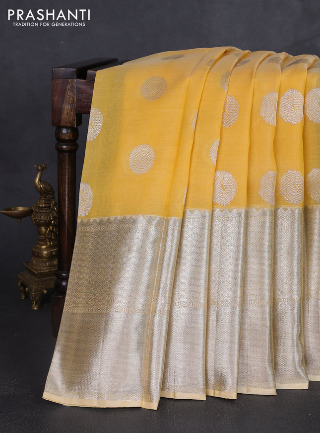 Kora kanchipuram silk saree yellow and pale yellow with silver zari woven buttas and long silver zari woven border