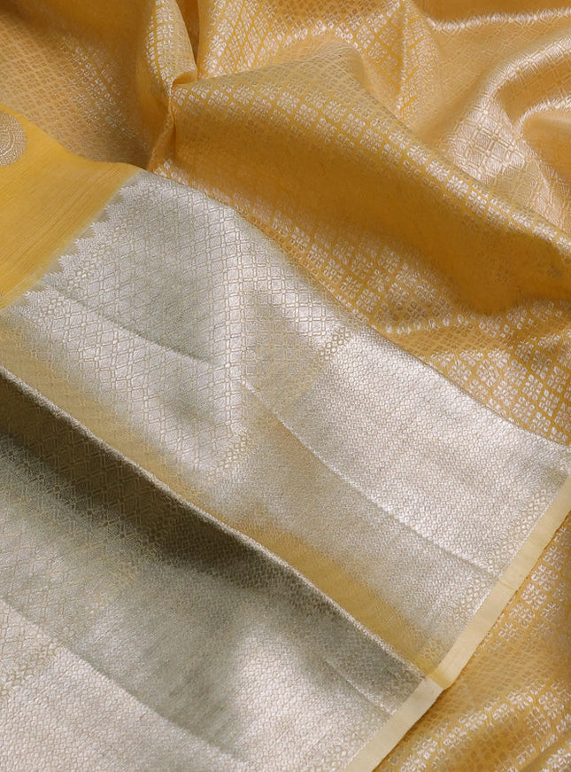 Kora kanchipuram silk saree yellow and pale yellow with silver zari woven buttas and long silver zari woven border