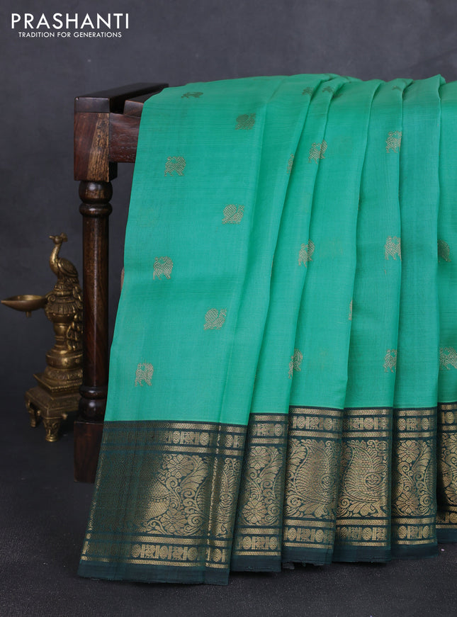 Kora kanchipuram silk saree teal blue and peacock green with zari woven buttas and annam zari woven border